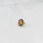 Gold nose pin design with multicolor floral stones on white background