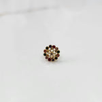 Gold nose pin design with multicolor floral stones on white background