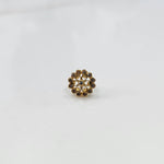 Gold nose pin design with white floral cluster on white background