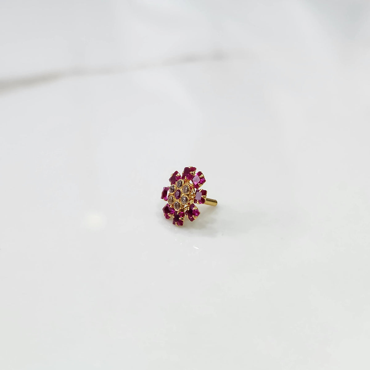 Gold nose pin with ruby square-cut and round-cut stone petals