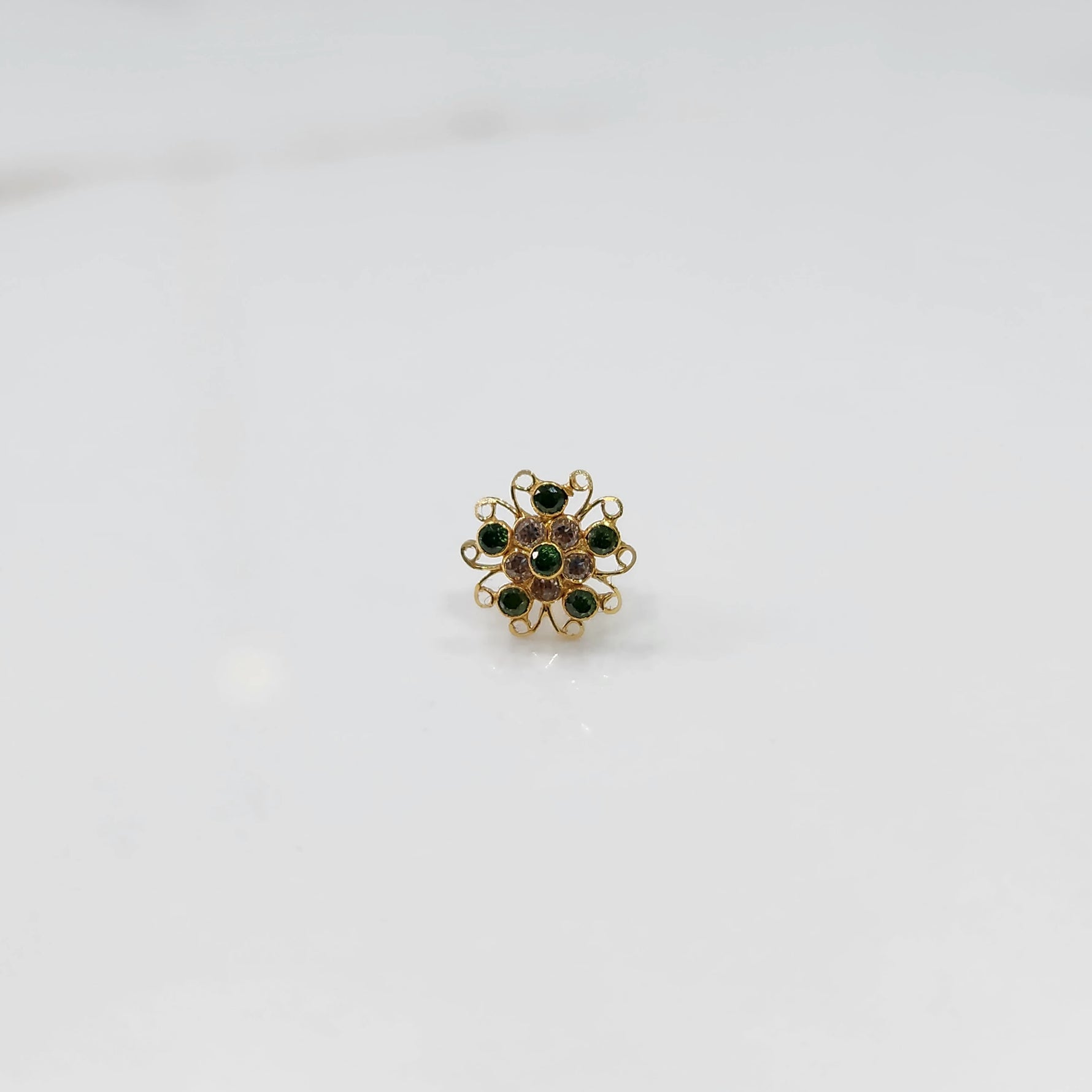 Nose pin new design gold with green stone floral pattern on white background