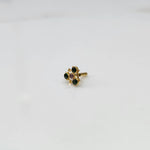 Gold nose pin with green and purple stones in organic branch-style setting