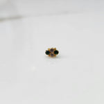 Gold nose pin with small green and purple stone cluster