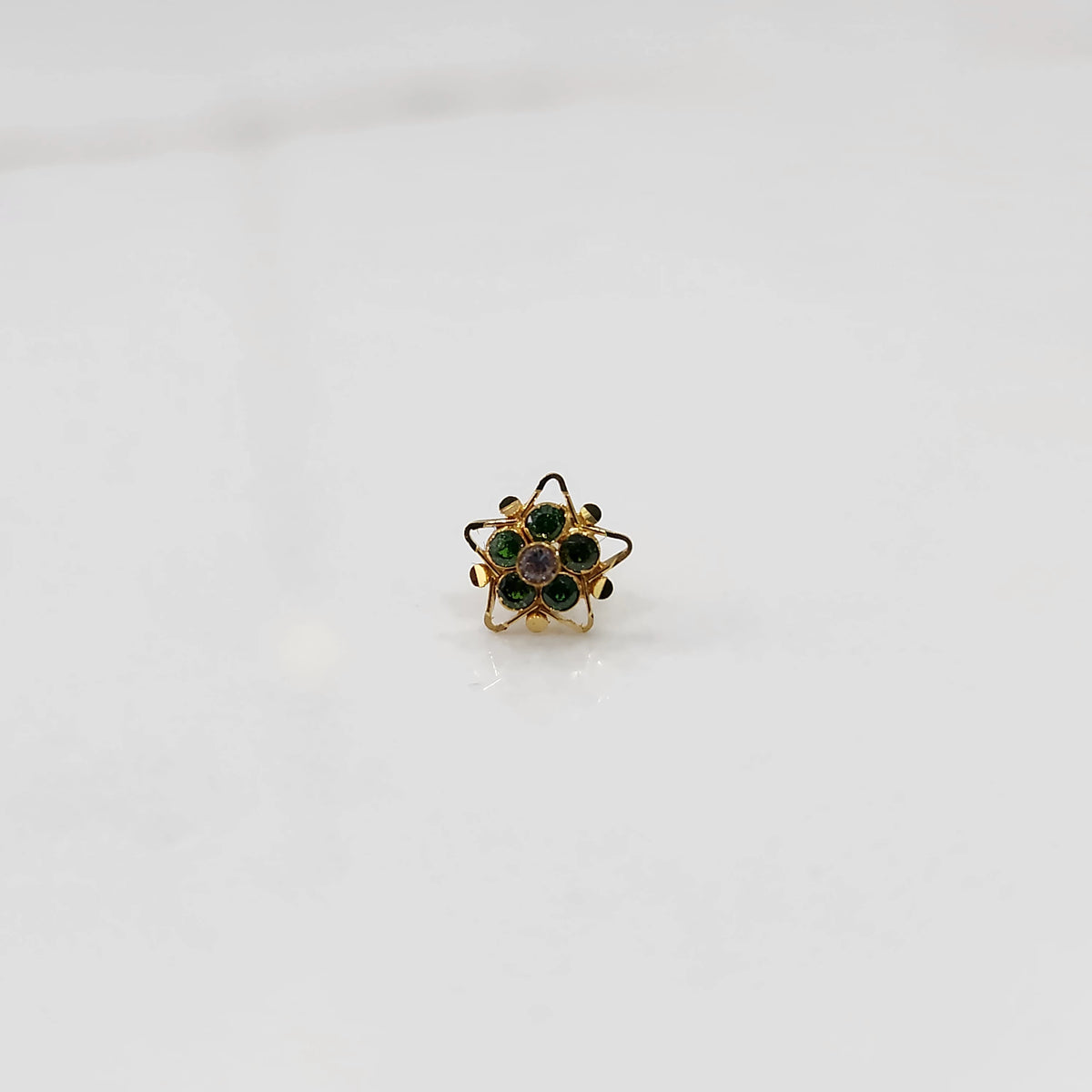 Nose pin design gold with blue stone floral pattern on white background
