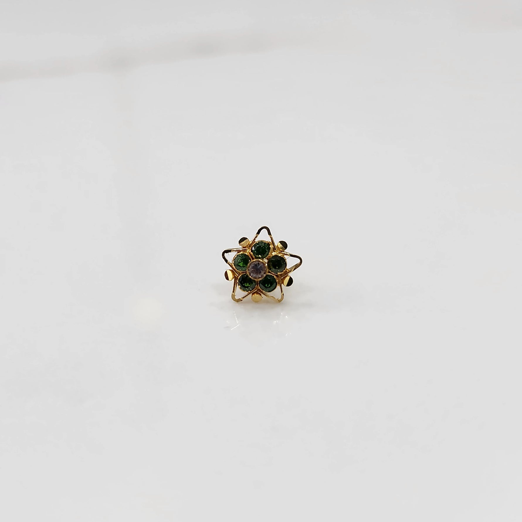 Nose pin design gold with blue stone floral pattern on white background