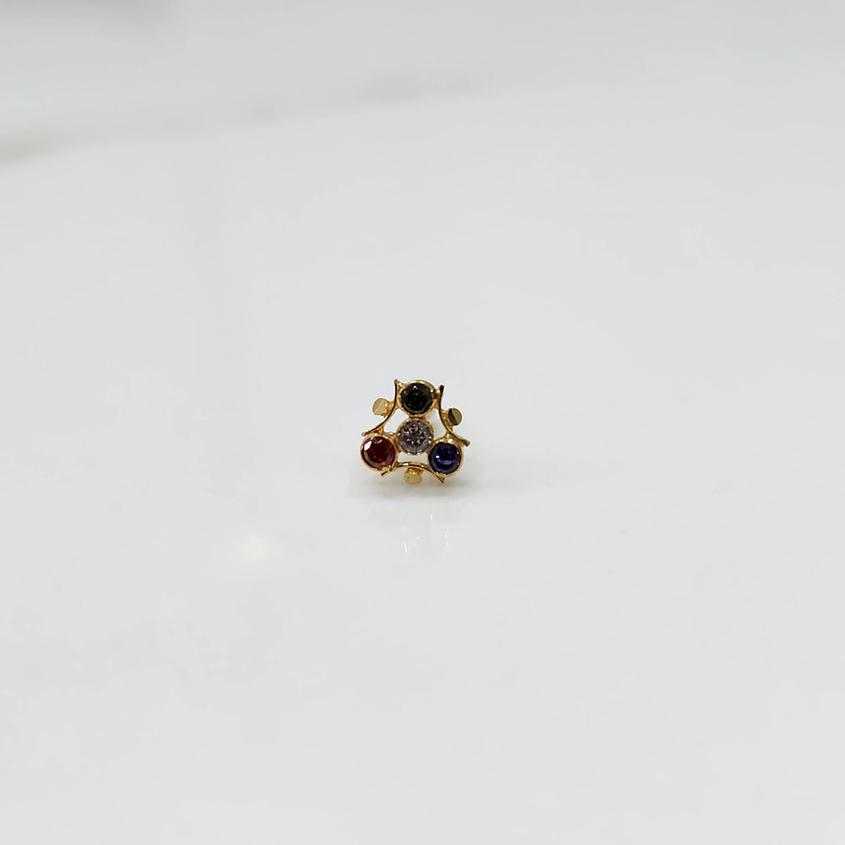 Gold nose pin with navratna multicolor stones in organic branch-style setting