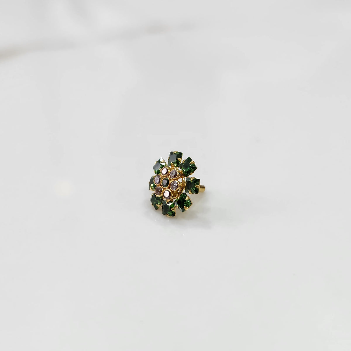 Gold nose pin with green square-cut stones and purple round center stones