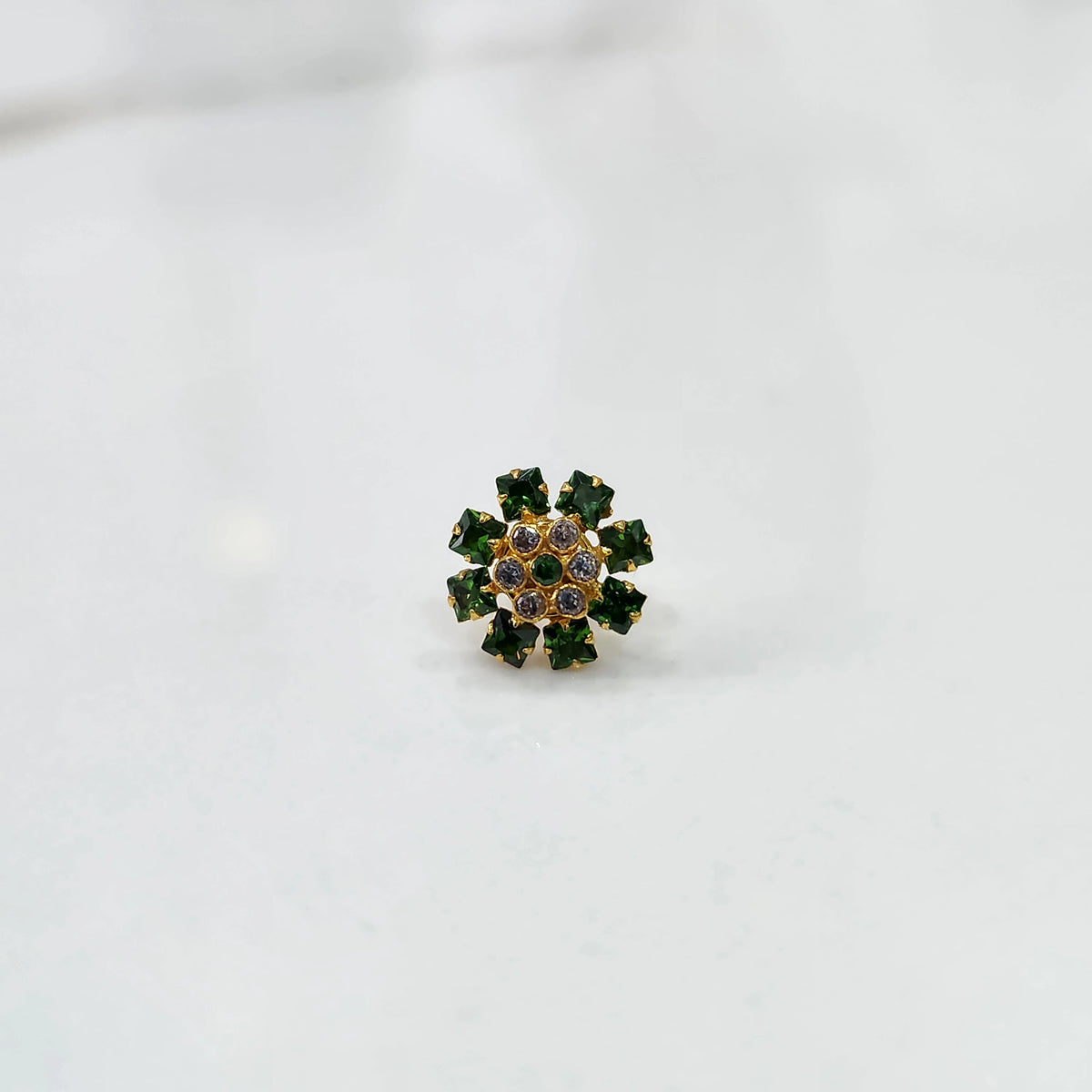 Gold nose pin with green square-cut stones and clear round center stones