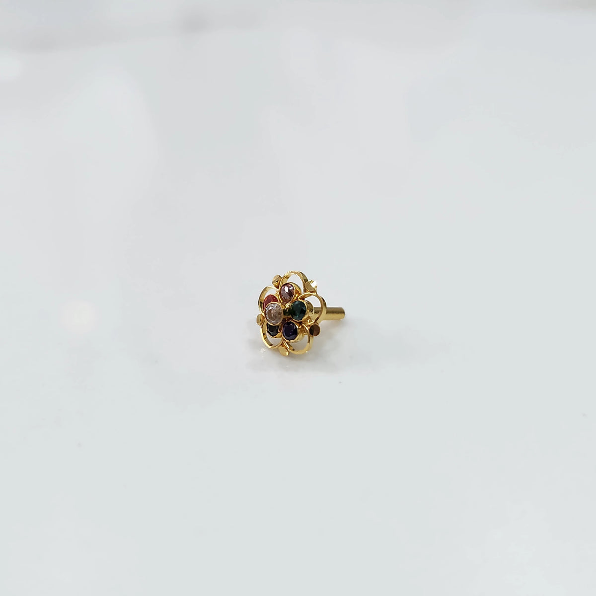 Gold floral nose pin with multicolor stones and open swirl border