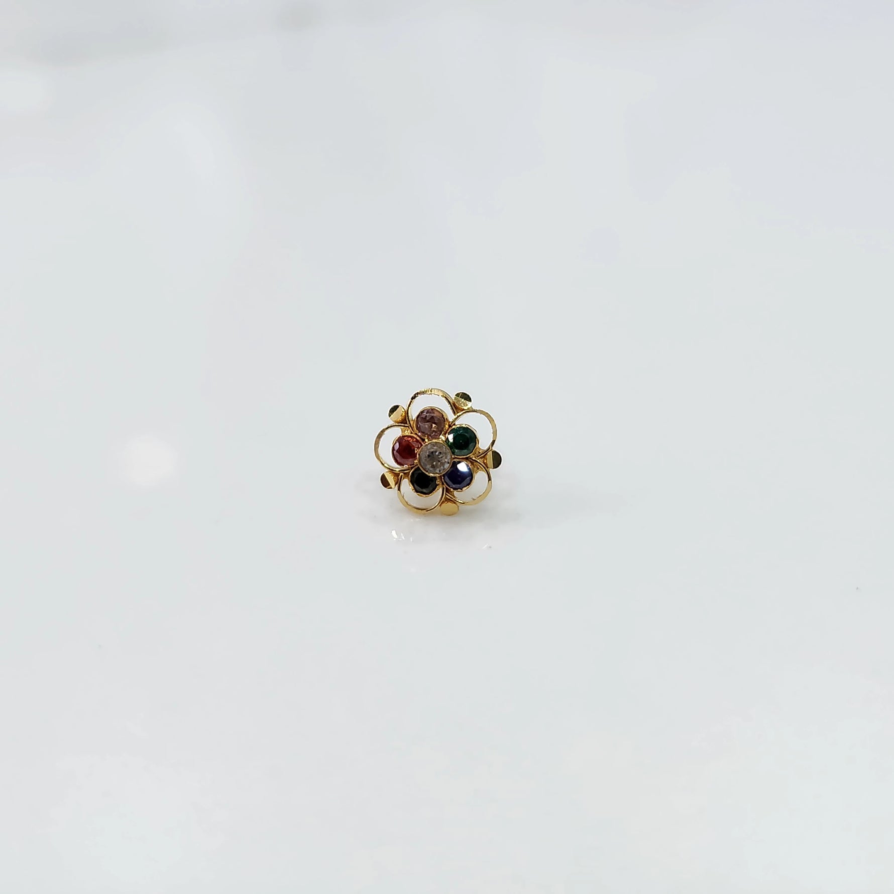 Gold floral nose pin with navratna nine-gem stone cluster