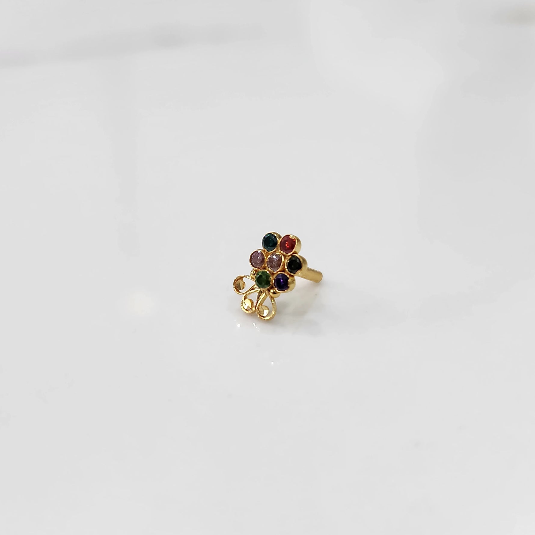 Lab grown diamond nose pin with multicolor stones on white background