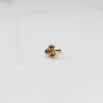 Tiny nose pin gold with delicate floral gemstone cluster on white background