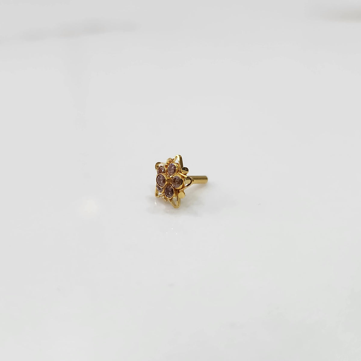 Nose pin design gold with red stone center and floral pattern