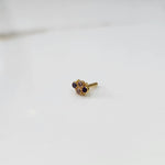 Women's gold nose pin design with floral cluster on white background