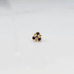 Tiny nose pin gold with floral pattern on white background