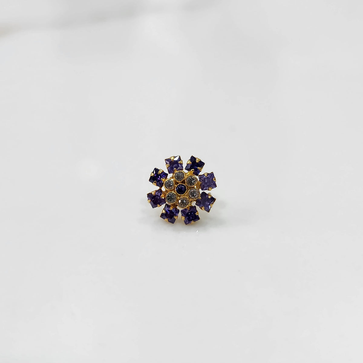 Gold nose pin with purple square-cut stones and clear round center stones