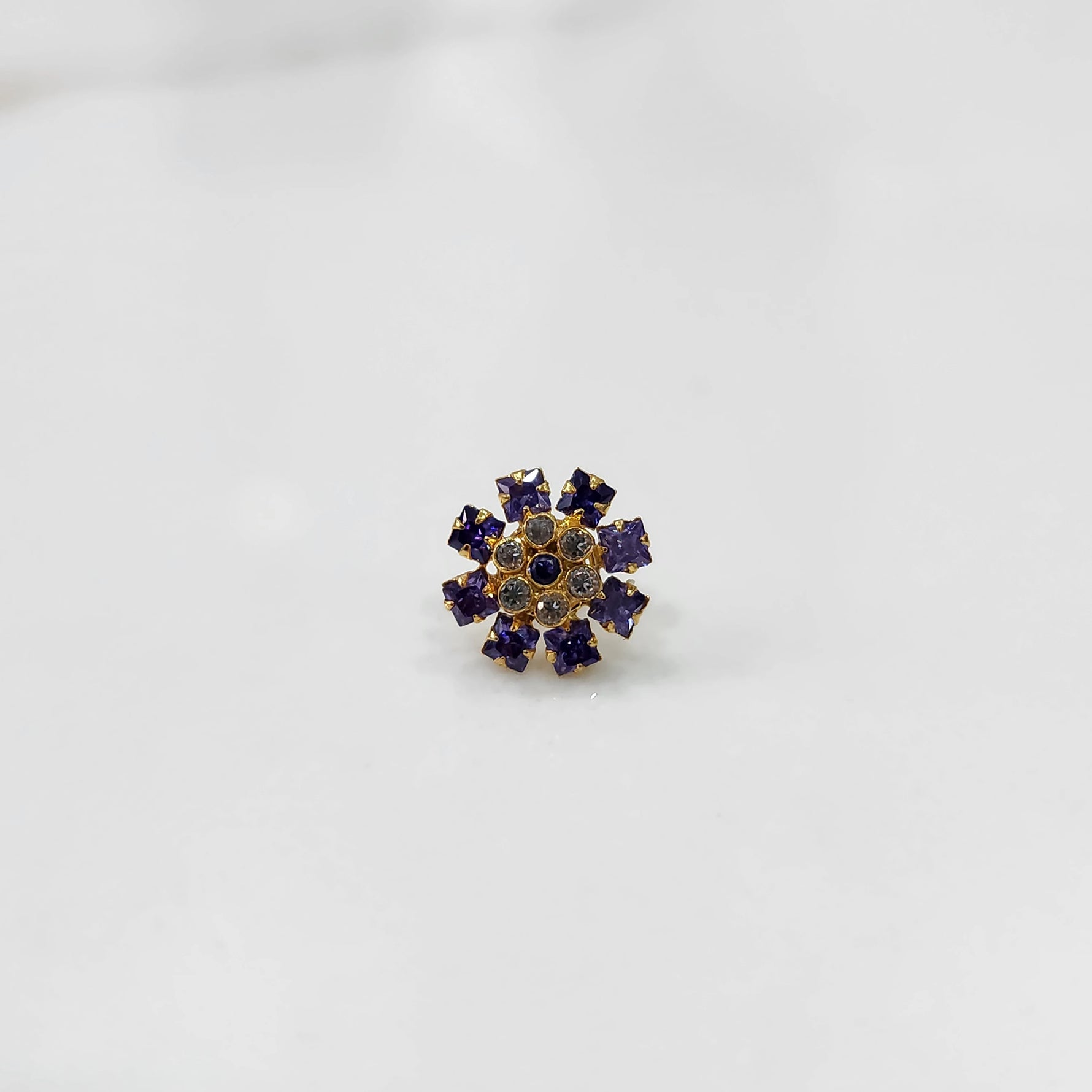 Gold nose pin with purple square-cut stones and clear round center stones