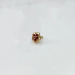 Gold floral nose pin with ruby stones and scalloped swirl border