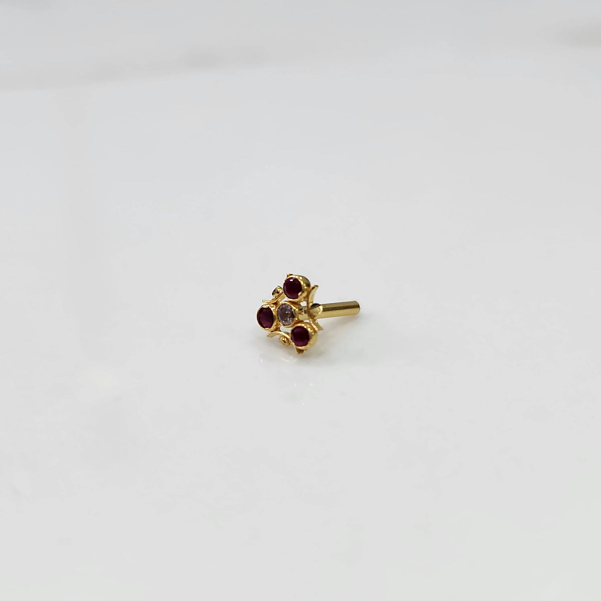 Side view tiny nose pin gold with small floral gemstone design