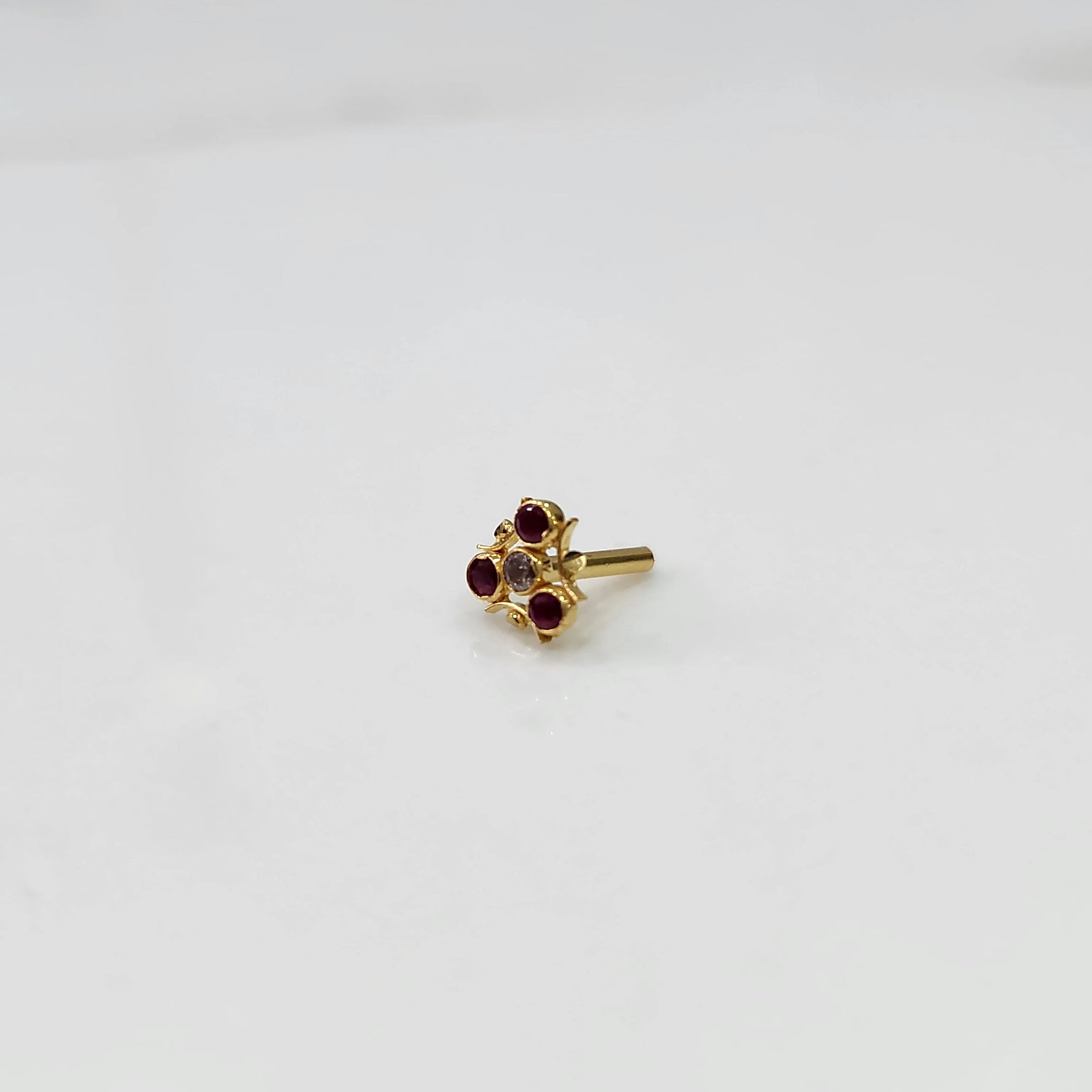 Side view tiny nose pin gold with small floral gemstone design