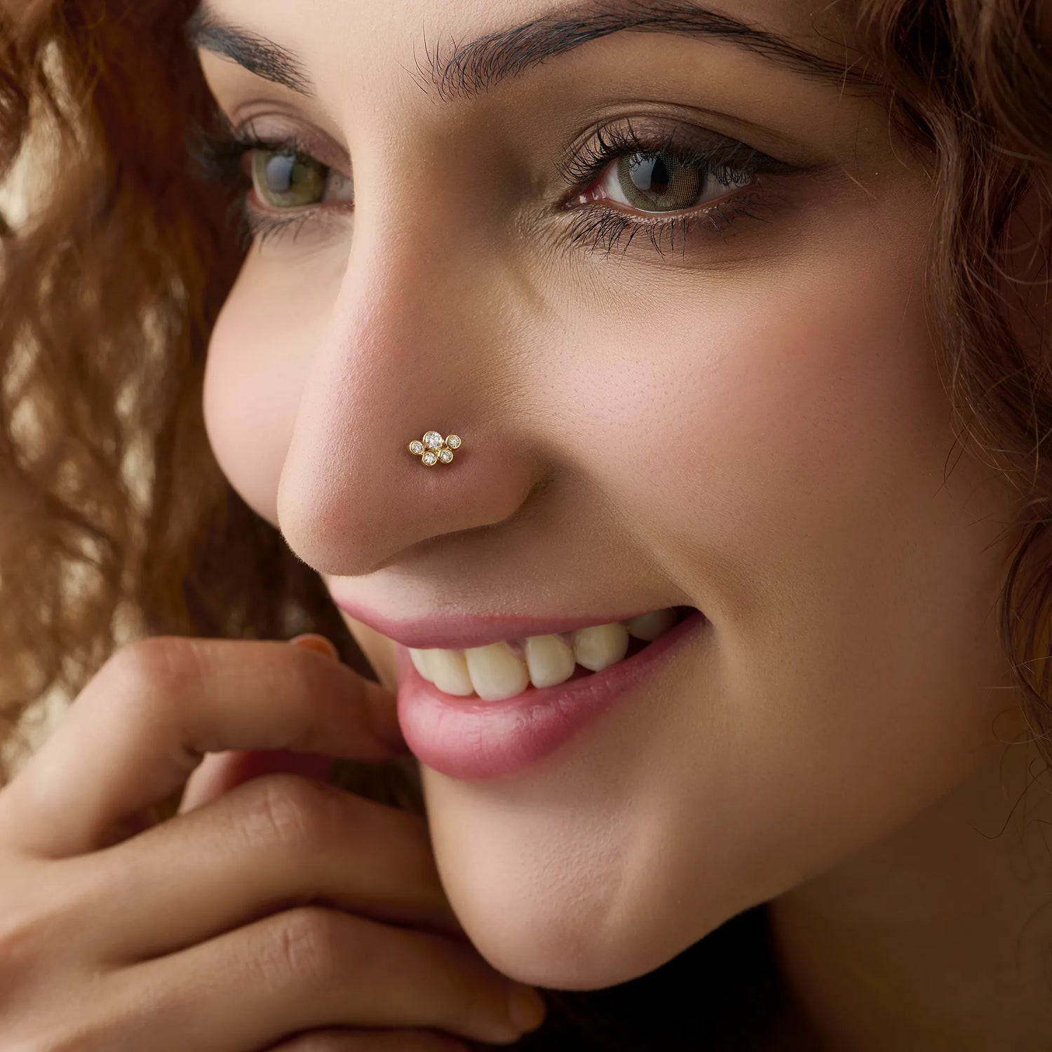 Woman wearing elegant lab grown diamond nose pin with subtle floral design