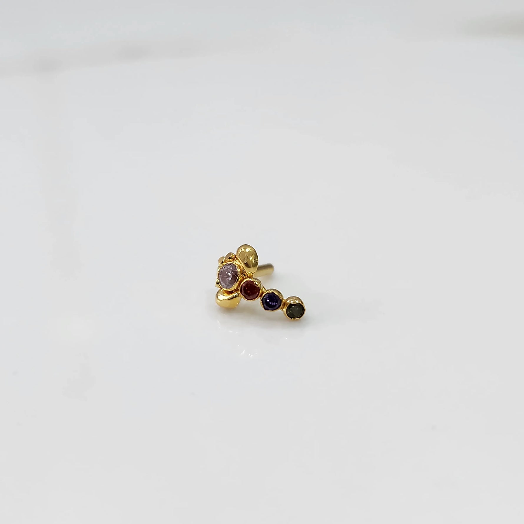 Gold nose pin with multicolor floral head and gemstone trail