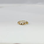 Gold Orbit Gold Nose Ring in 18K gold displayed on a flat surface with intricate orbit-inspired design