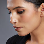 Model wearing Gold Orbit Gold Nose Ring in 18K gold with celestial-inspired design by Yuvora