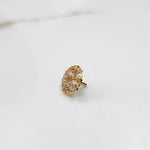 Front view of gold ring with oval floral clear gemstone cluster design