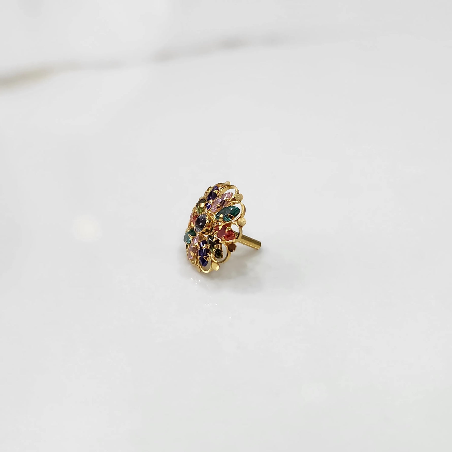 Gold oval ring with multicolor gemstones, front view