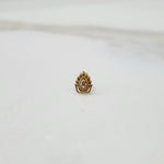 Gold peacock feather nose stud with deity motif, front view