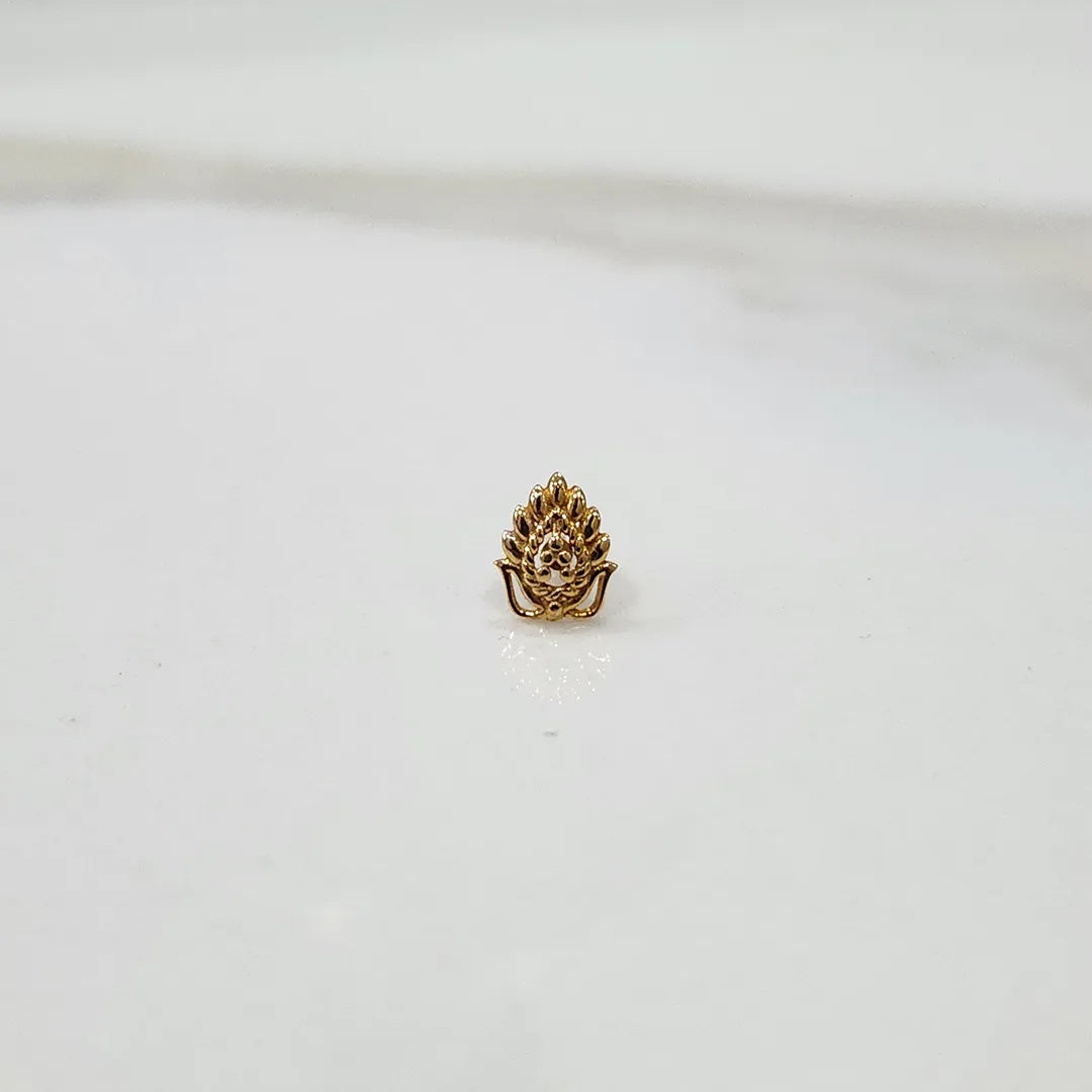 Gold peacock feather nose stud with deity motif, front view