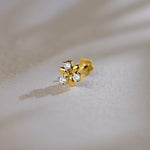 Flower-shaped stud earring with sculpted gold petals and diamond accents