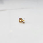 Gold nose pin with pink gemstone cluster and clear drop-style stone accent on white background