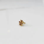 Gold nose pin with pink gemstone flower cluster on white background