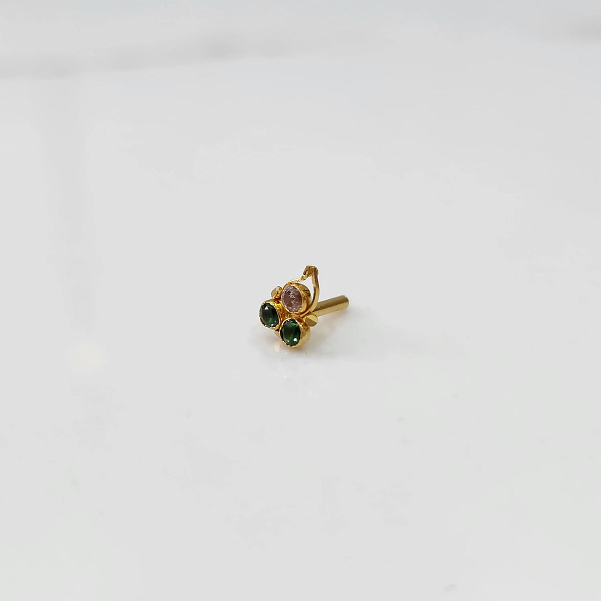 Gold nose pin with pink and green stones, product shot