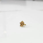 Gold statement ring with pink gemstones in textured flower cluster design