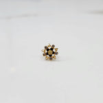 Top view of gold pointed petal ring with black enamel accents