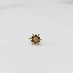 Gold statement ring with purple-brown gemstones in scattered dotted cluster design