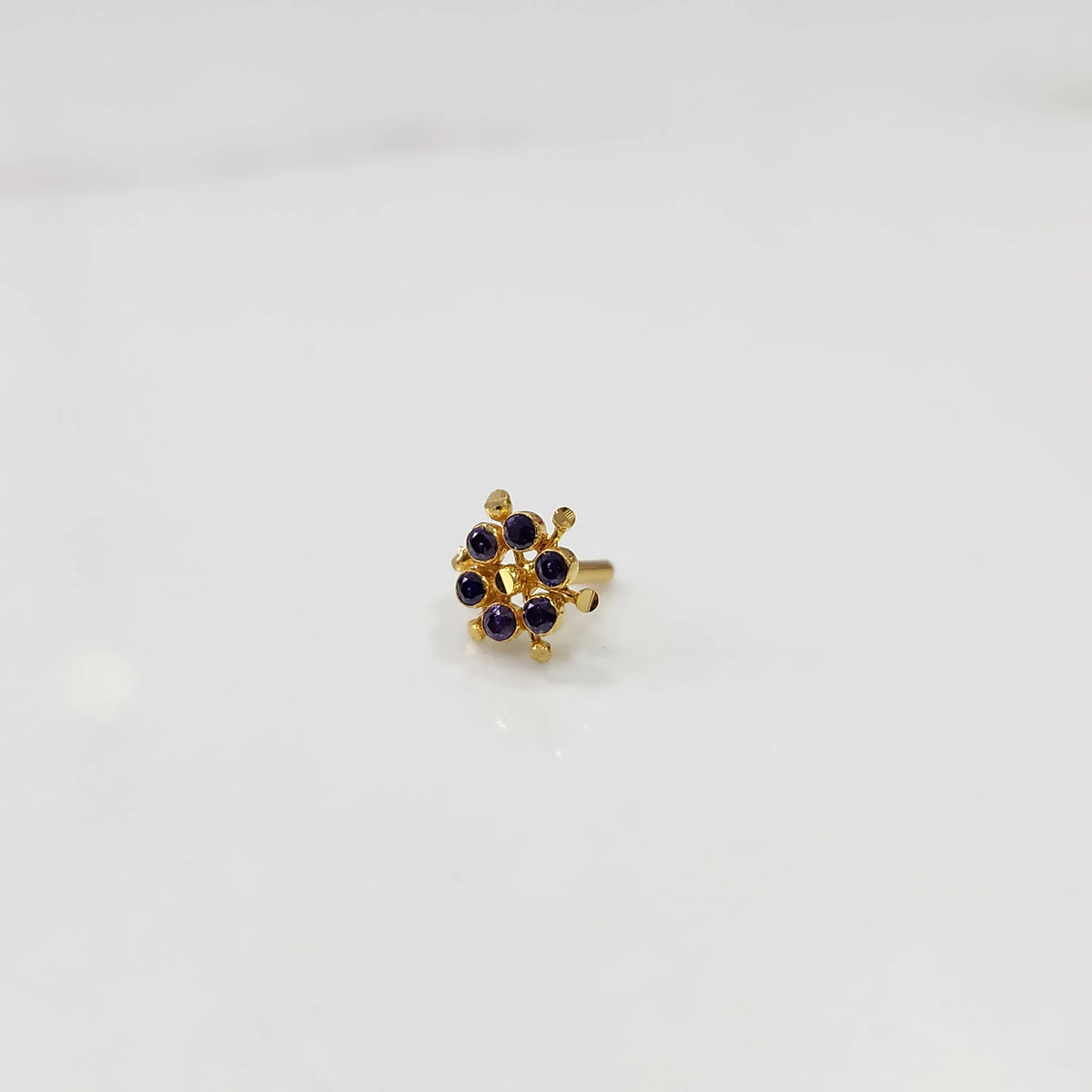 Gold statement ring with purple cabochon gemstones in scattered dotted cluster design