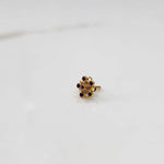 Gold nose pin with purple gemstone mandala design on white background