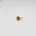Gold floral nose pin with purple stones, product shot