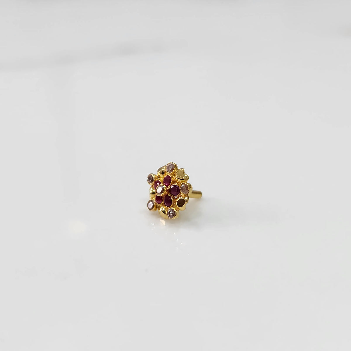 Gold statement ring with red and brown gemstones in textured floral cluster design