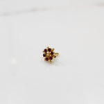 Gold statement ring with red cabochon gemstones in scattered dotted cluster design