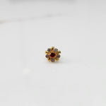 Gold floral nose pin with red center stone, product shot
