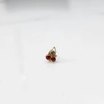 Side view of gold statement ring with red and clear gemstones in cluster design