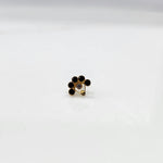 Gold ring with black and clear flower cluster and dangling drop stone