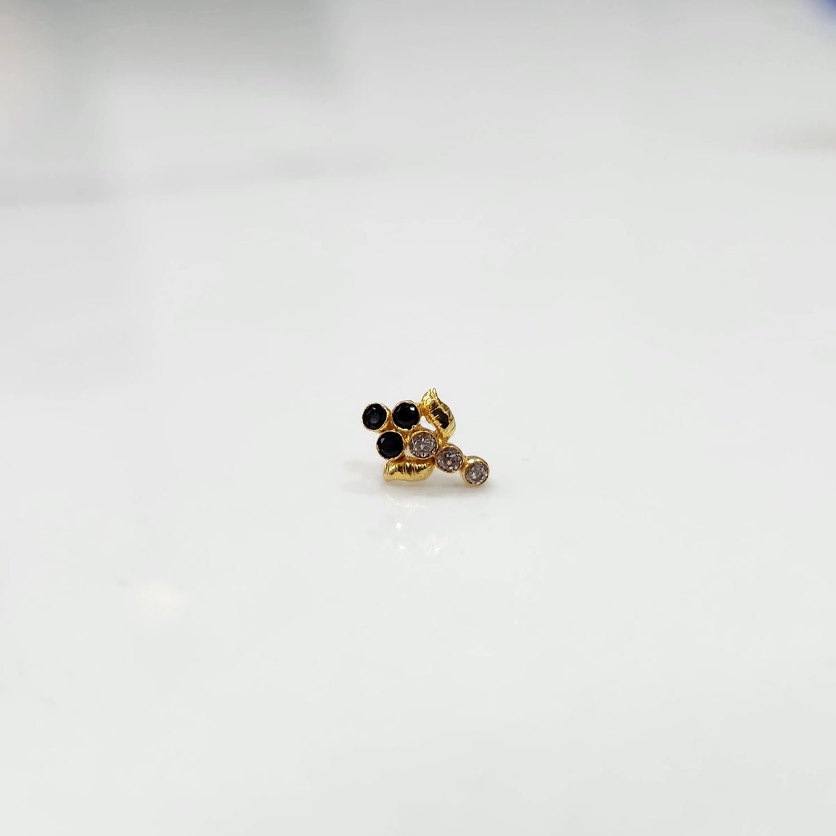 Gold ring with black onyx and purple gemstone leaf-charm cluster design, side view