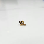 Gold ring with black onyx and purple gemstone leaf-charm cluster design, side view