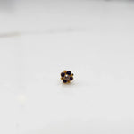 Gold ring with blue sapphire round floral design, front view
